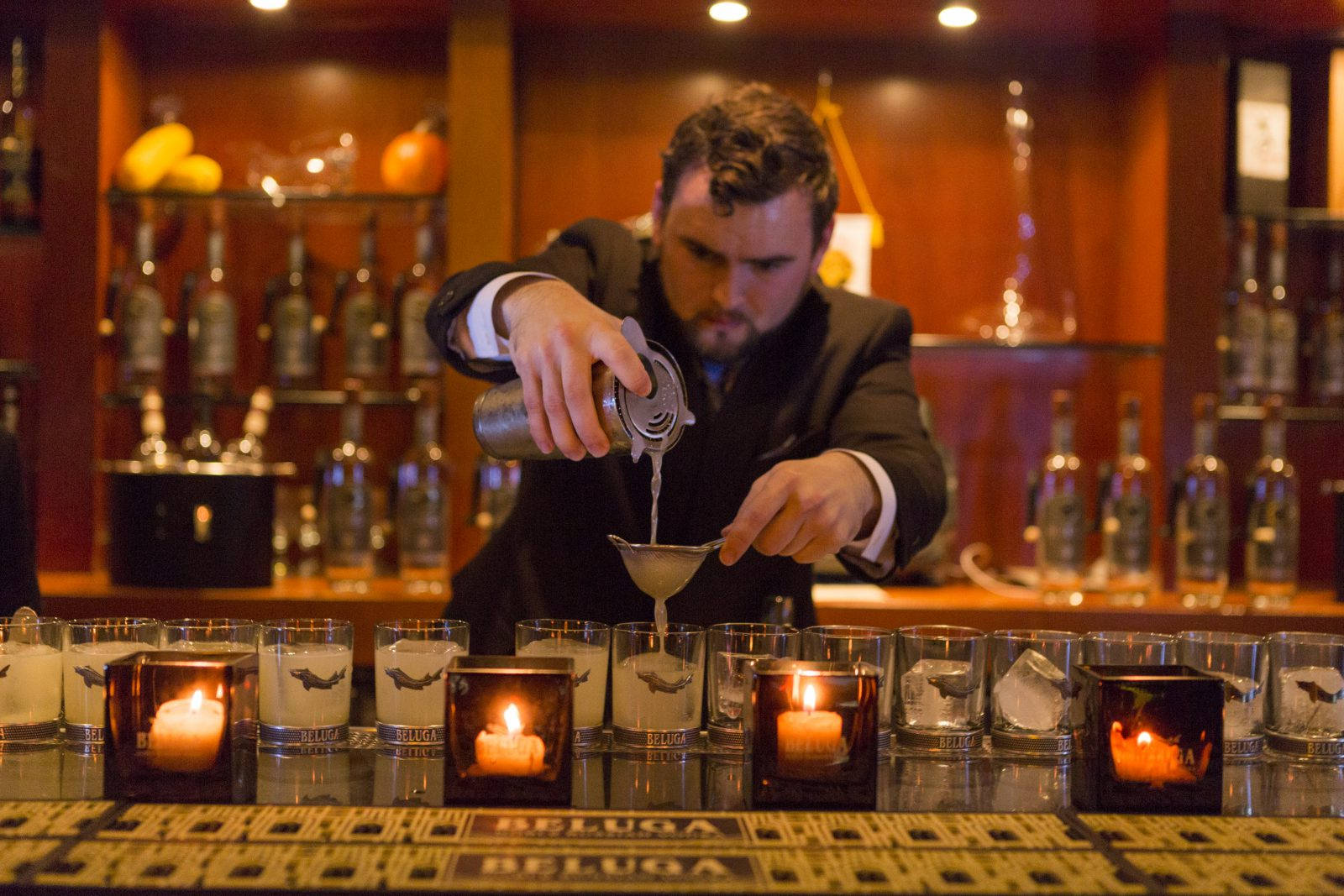 Bartender Mixing Beluga Vodka Drinks In Bar Wallpaper