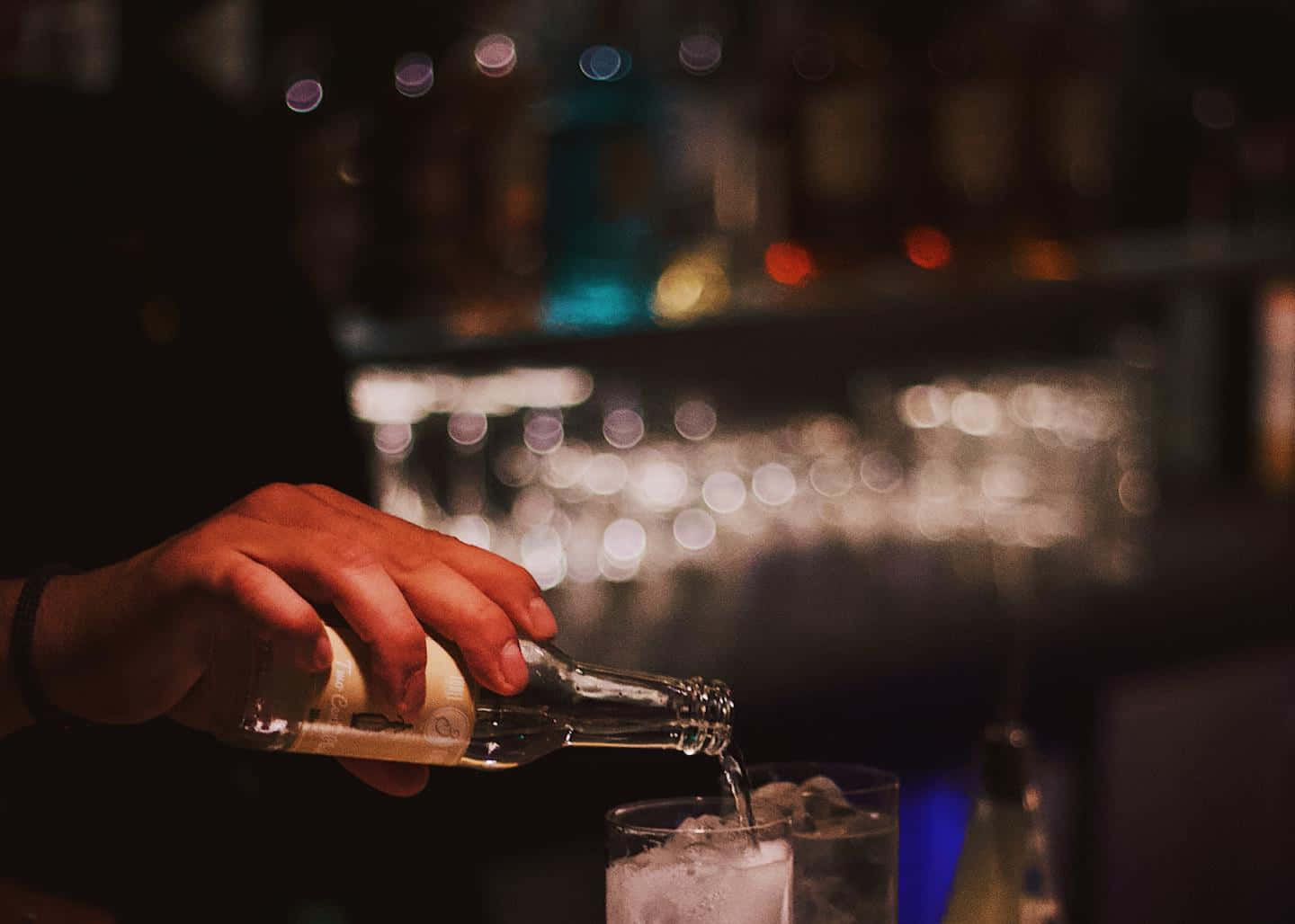 Bartender Pouring Drinkat Bar Wallpaper