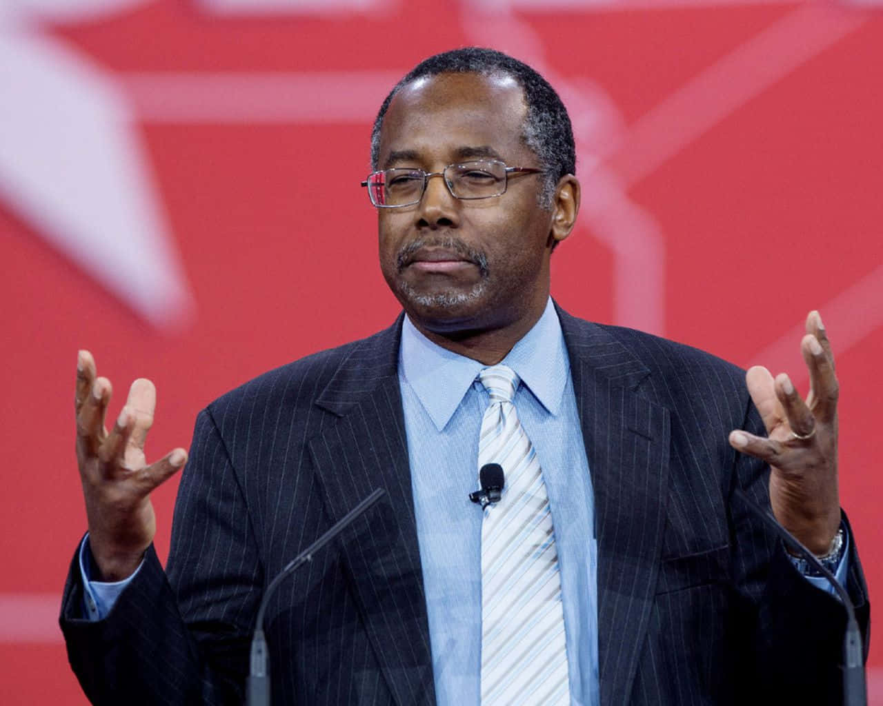 Ben Carson Expressively Speaking At An Event Wallpaper