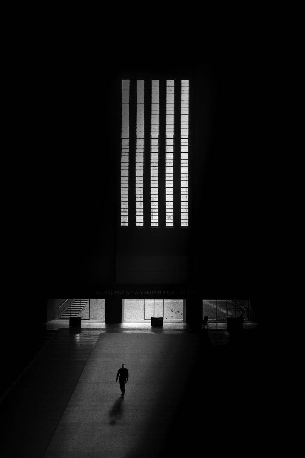 Blank And White Man Entering Building Wallpaper