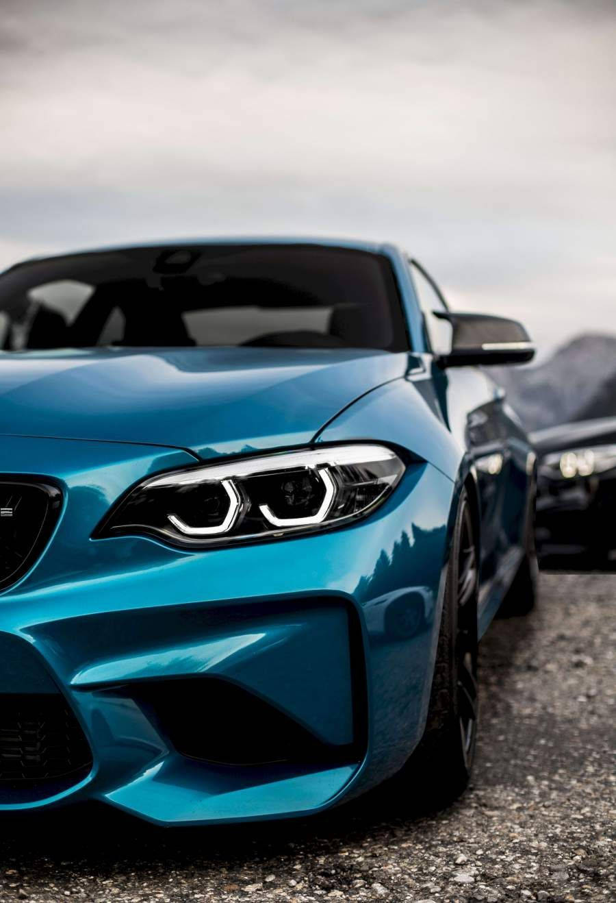 Blue Bmw Parked On Gravels Wallpaper