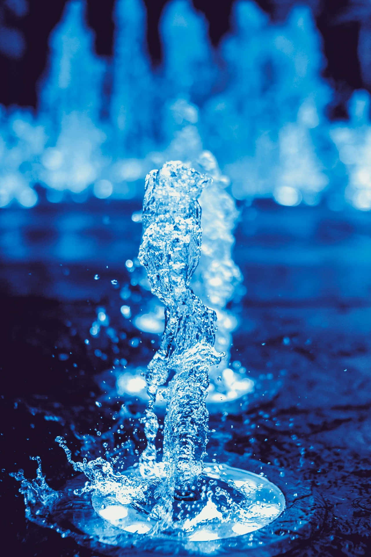 Blue Illuminated Water Fountain Stream Wallpaper