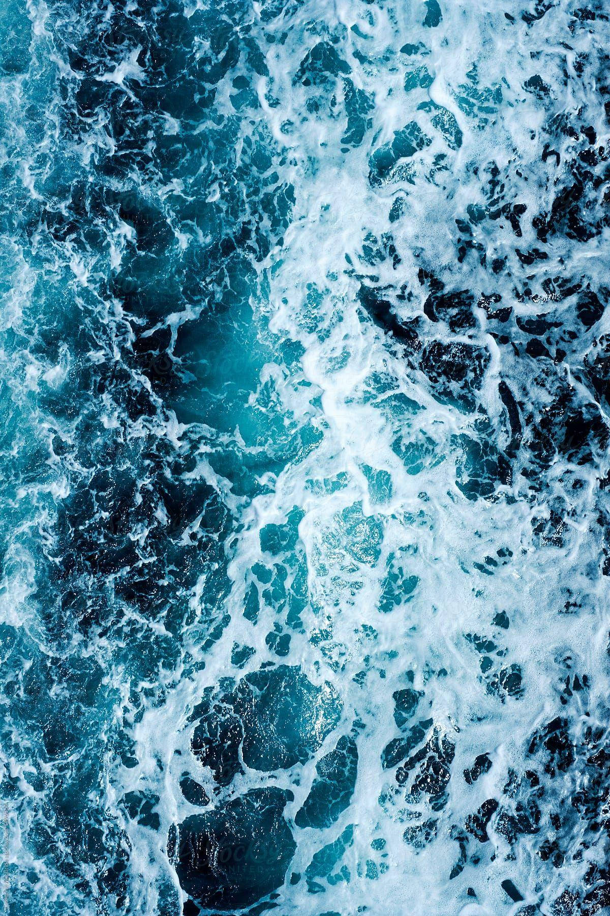 Blue Water With White Foam On The Surface Wallpaper