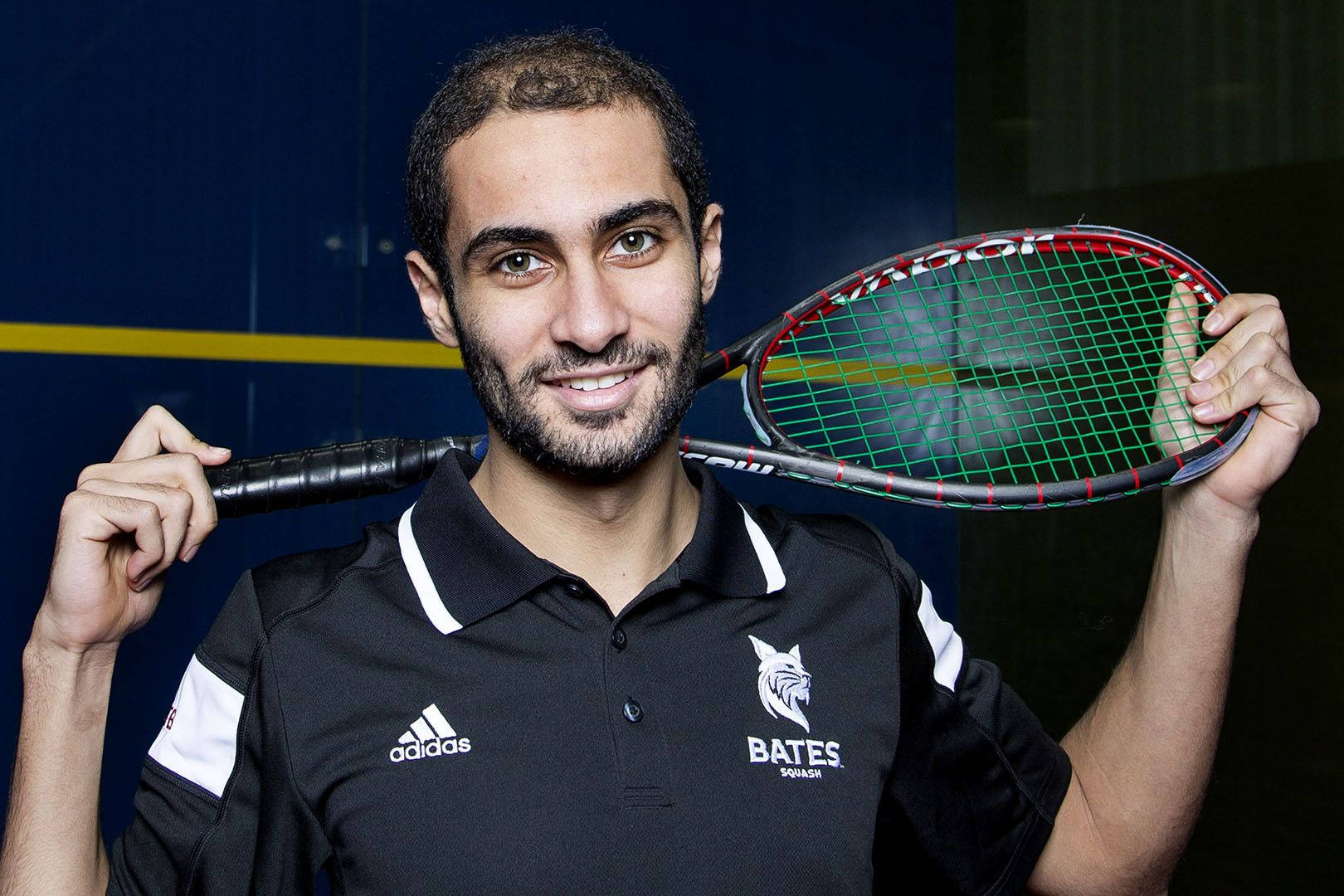 Boy Posing With Squash Racket Wallpaper