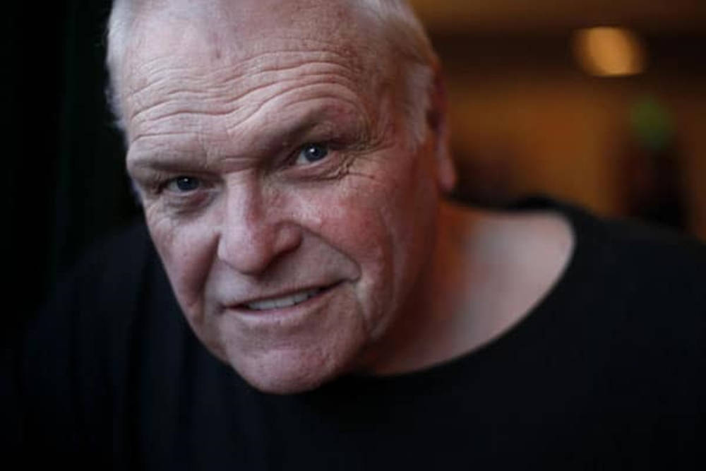 Brian Dennehy Grinning In Black Shirt Wallpaper