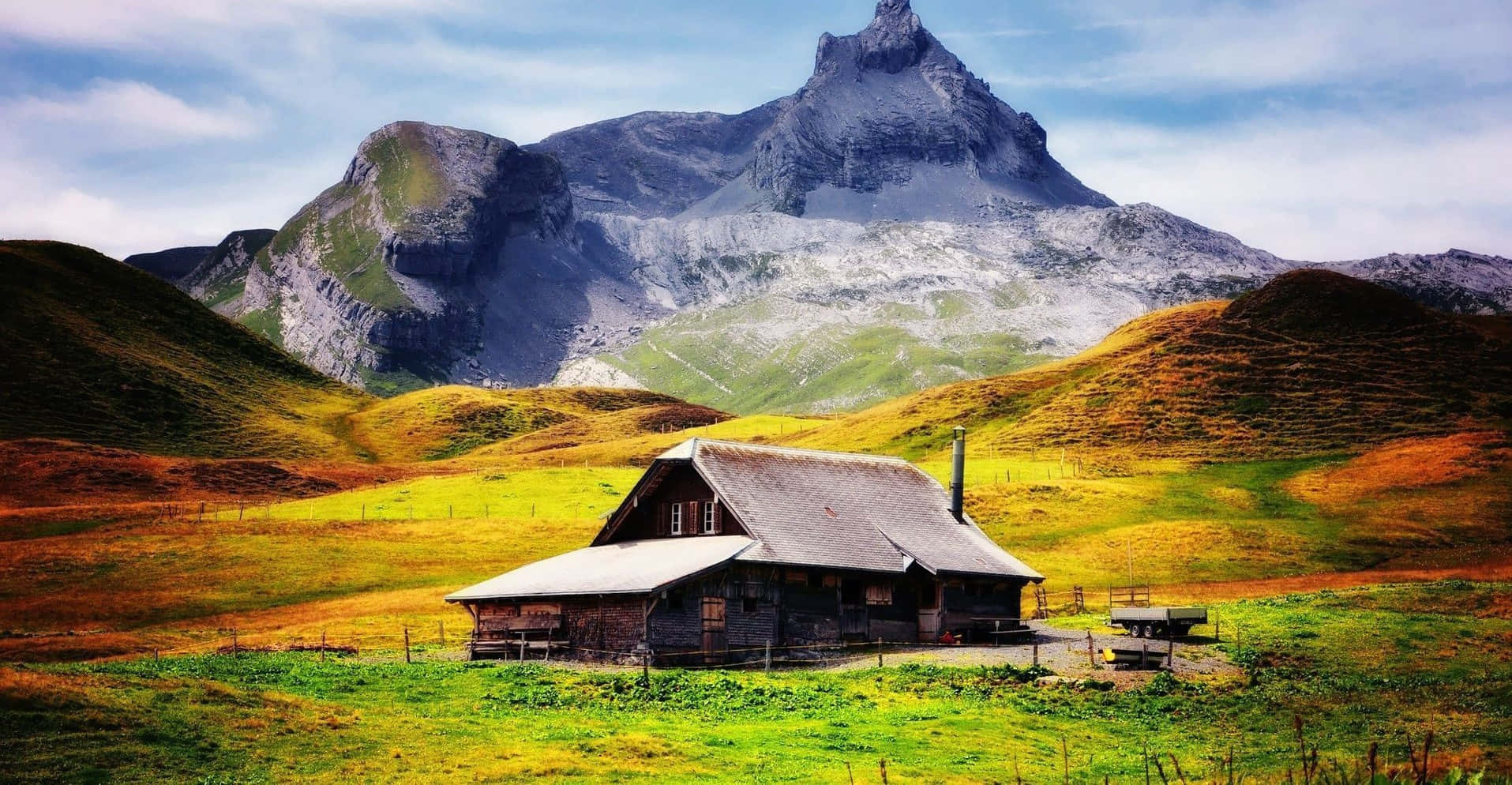 Cabin Overlooking A Snowy Mountain Wallpaper