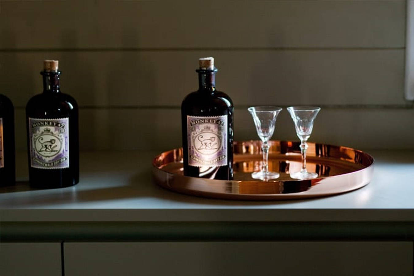 Caption: A Sophisticated Symmetry Of Monkey 47 Schwarzwald Dry Gin On Display Wallpaper