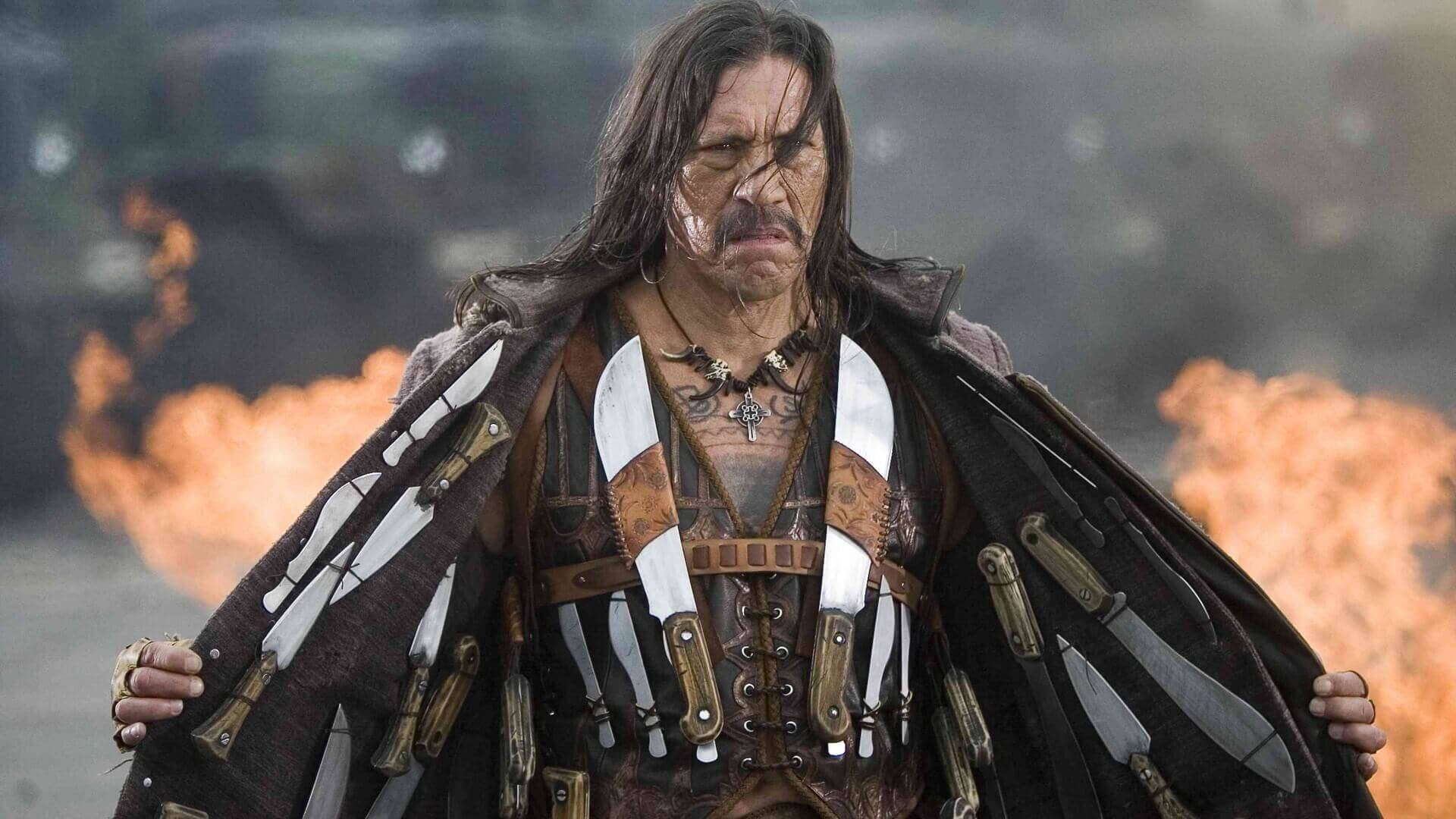 Caption: Danny Trejo Posing With Weapons As Machete Wallpaper