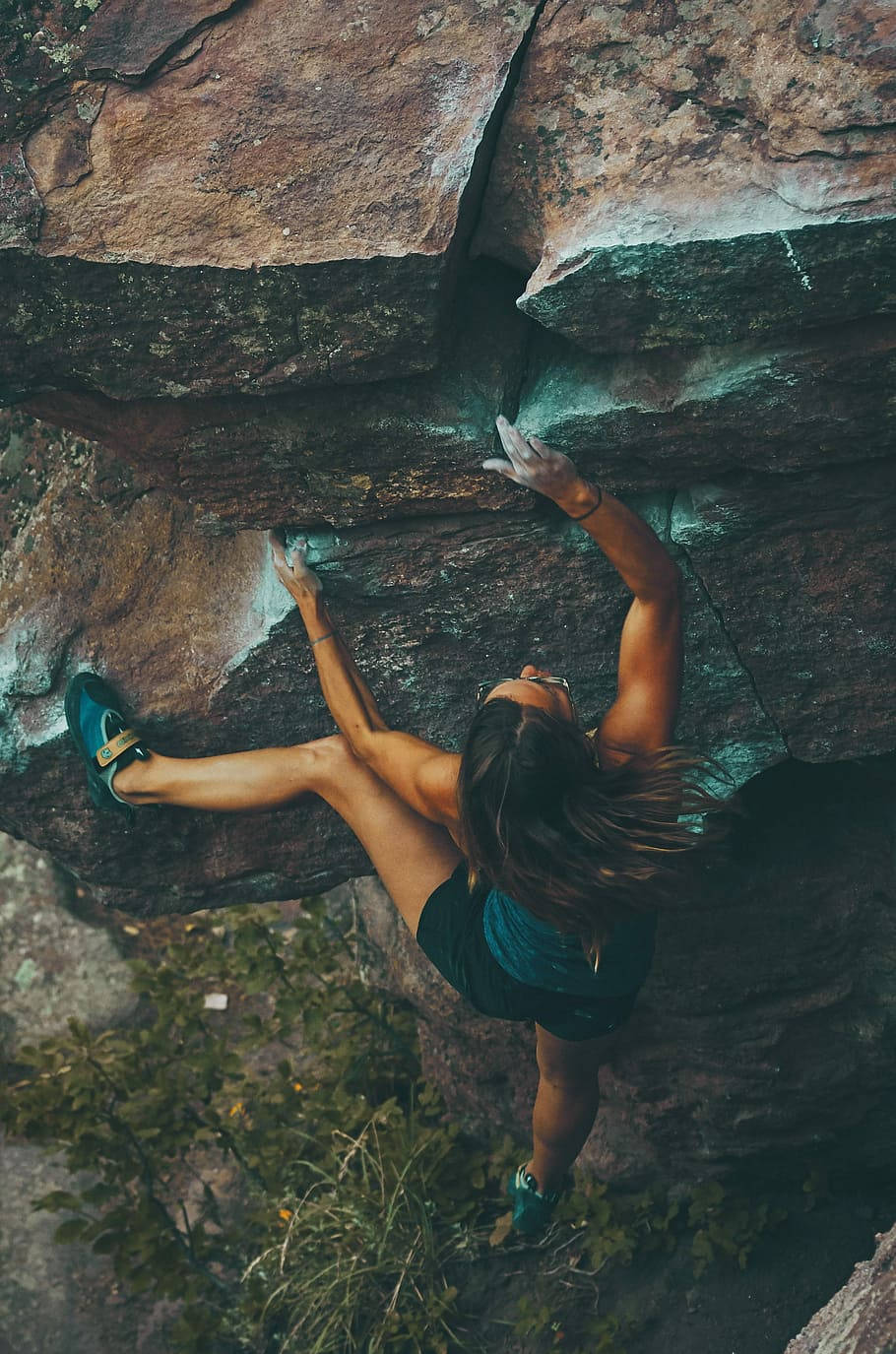 Caption: Determined Female Climber Conquers Mountain Summit Wallpaper