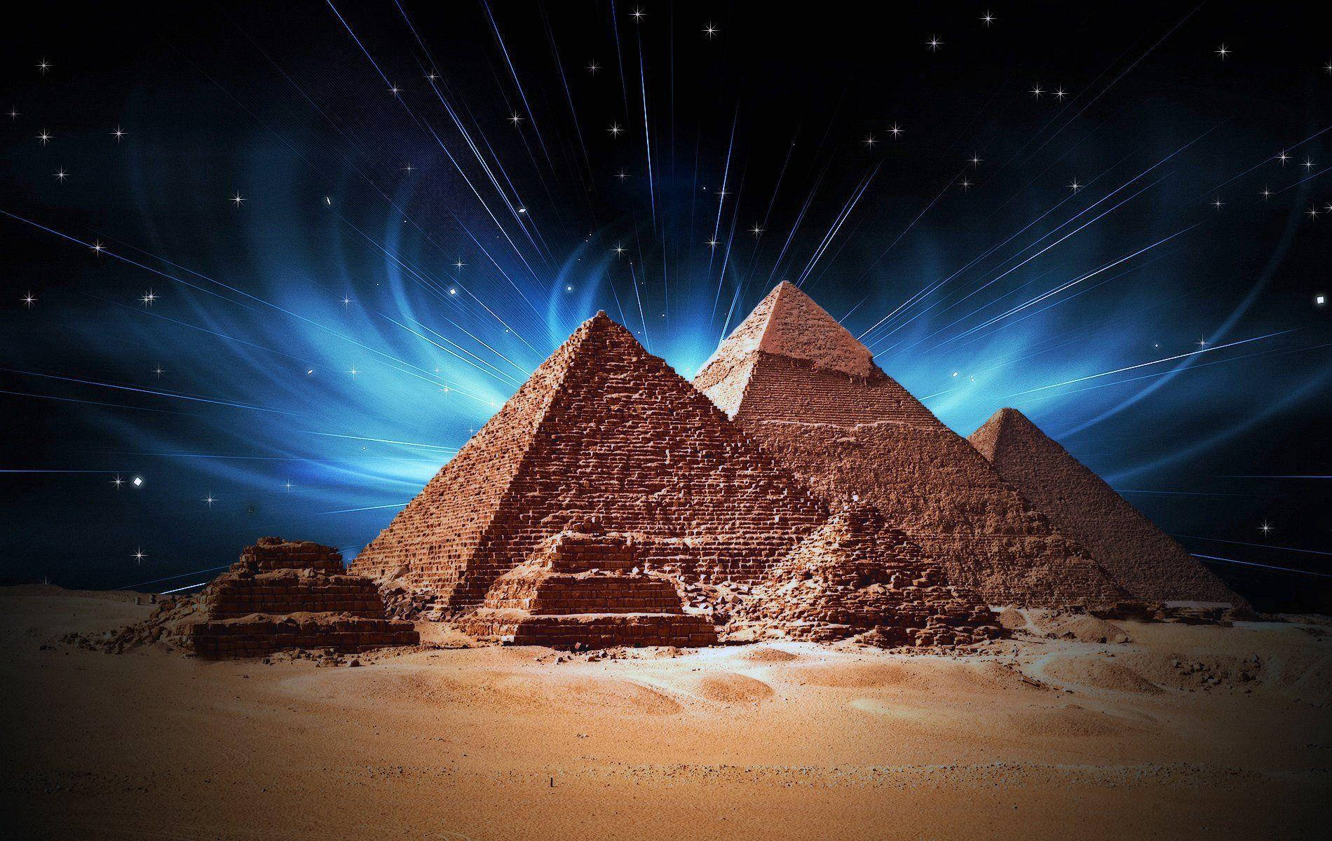 Caption: Majestic Illumination Of Cairo Pyramids At Night Wallpaper