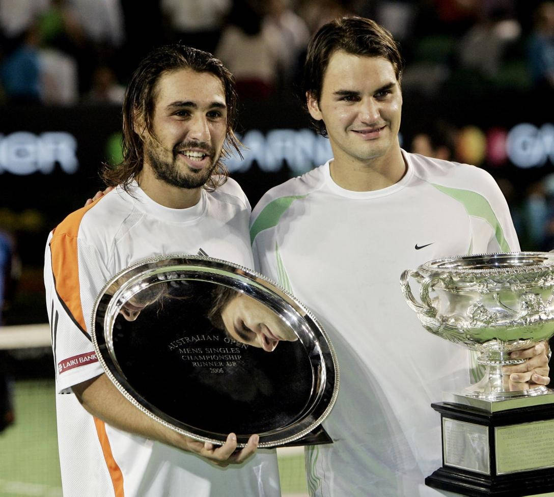 Caption: Marcos Baghdatis Engrossed In A Gripping Match With Roger Federer Wallpaper