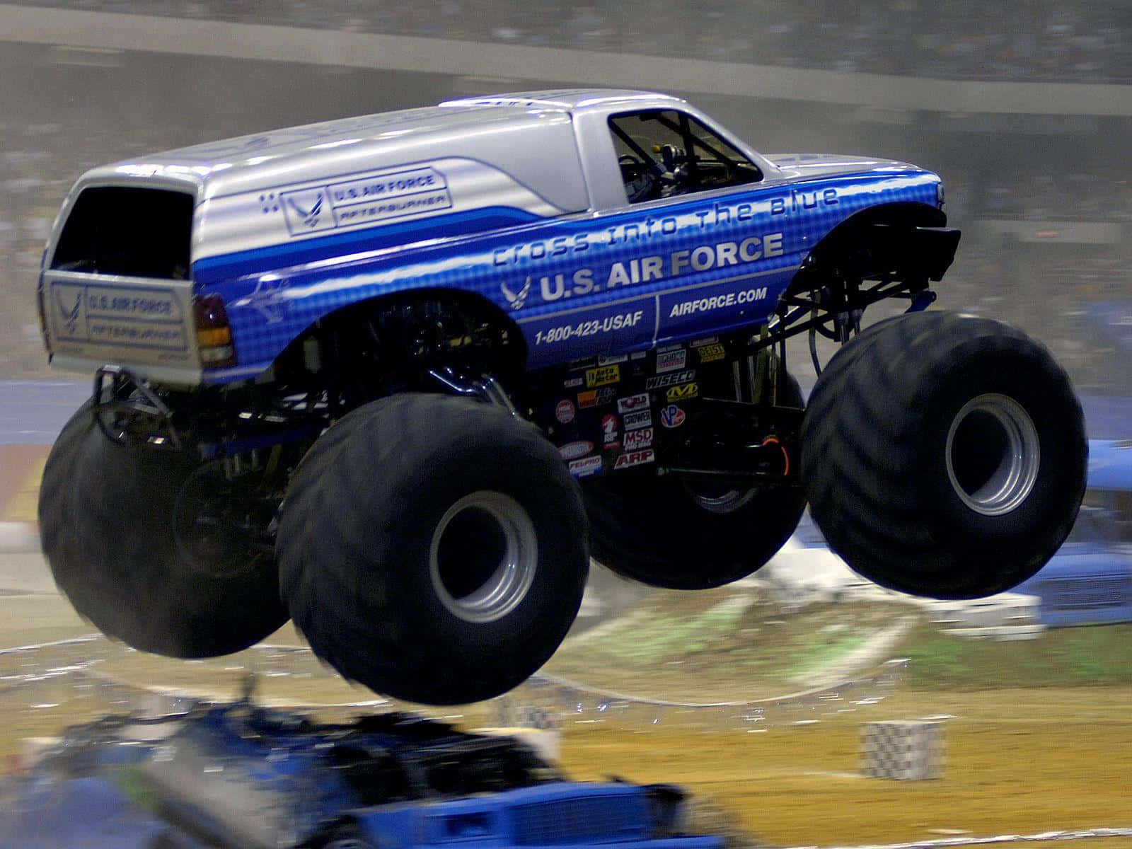 Caption: Roaring Power Unleashed – The Monster Truck Showdown Wallpaper