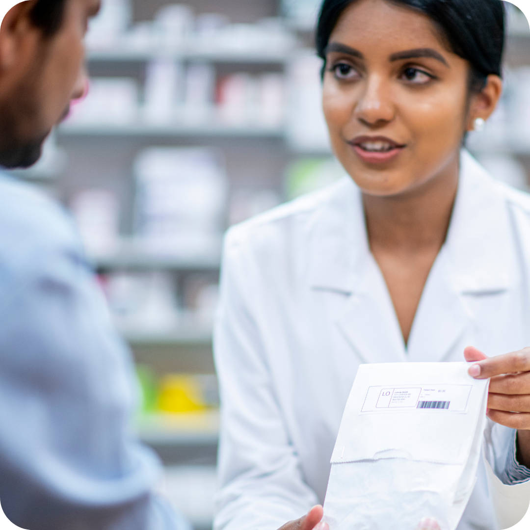 Caption: Skilled Pharmacist Assisting A Customer Wallpaper