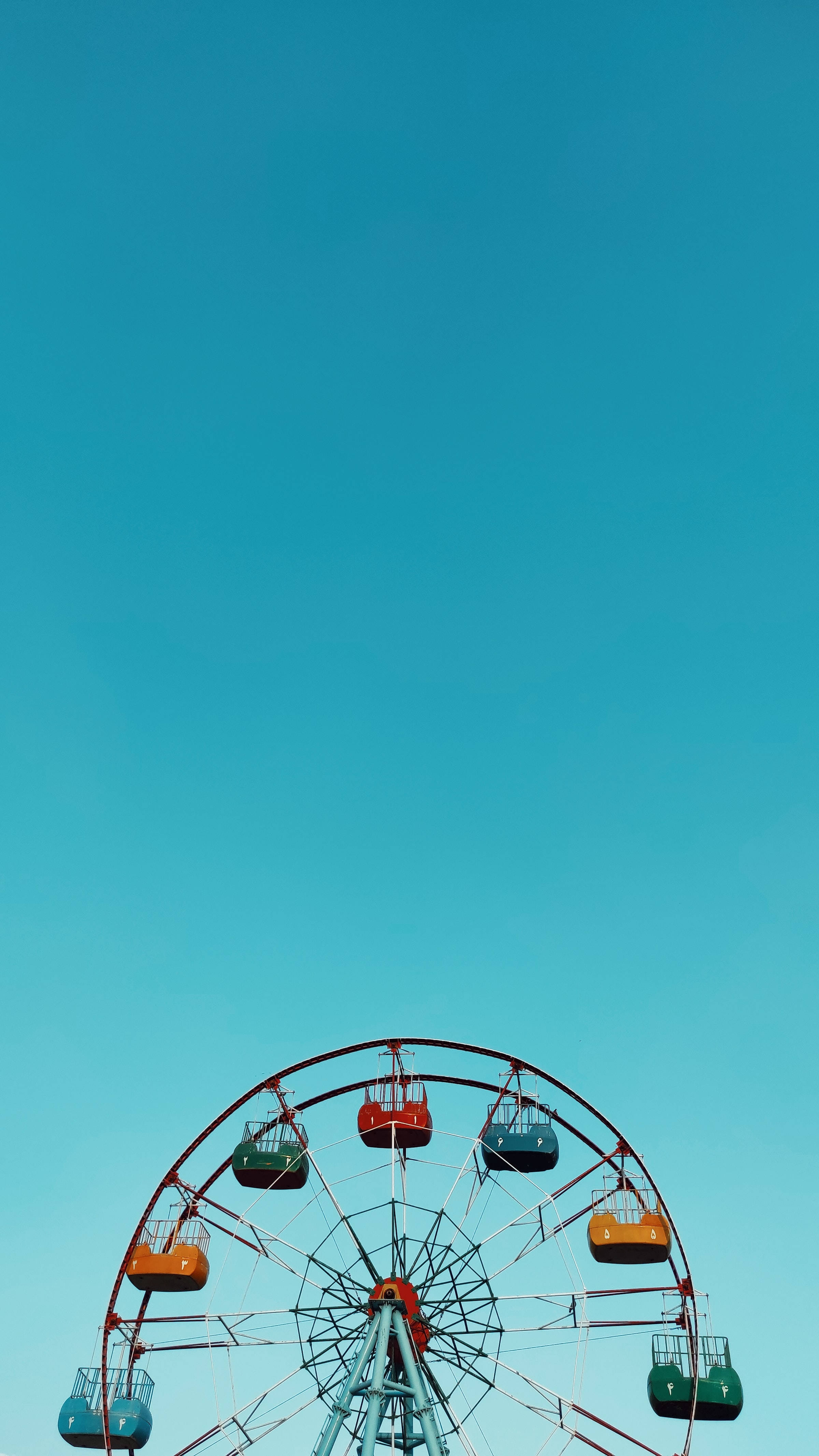 Caption: Whimsical Blue Ferris Wheel In Minimalist Style Wallpaper