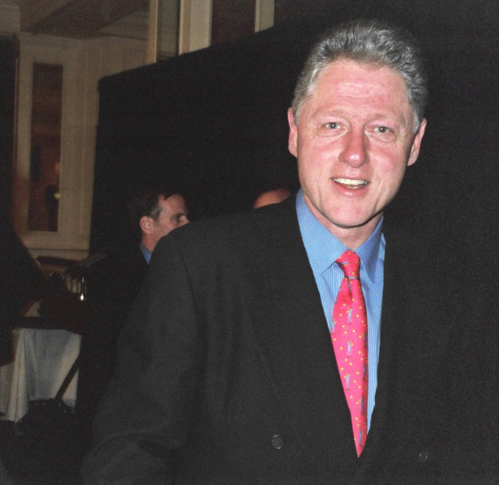 Charismatic Bill Clinton In Sharp Black Suit Wallpaper