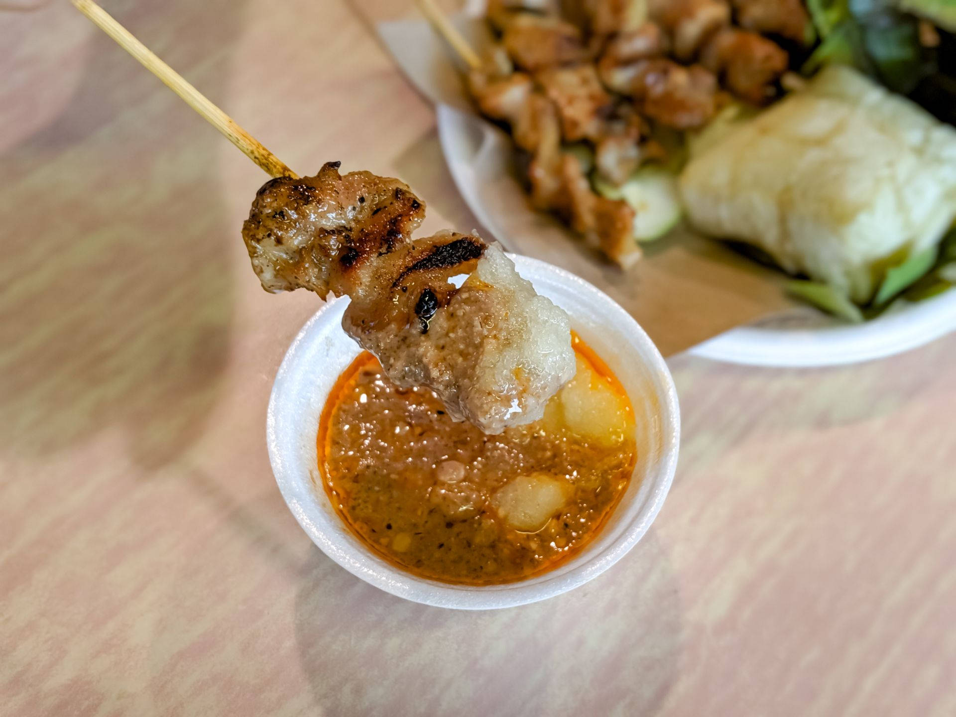 Chicken Satay Dipped In Sauce Wallpaper