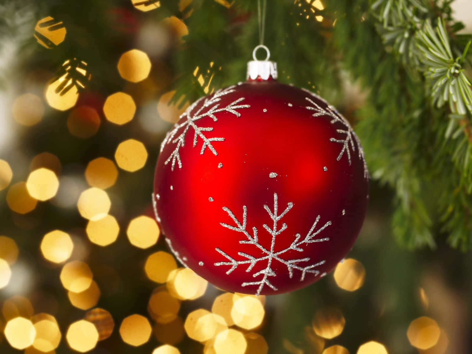 Christmas Ornaments Hanging Off The Tree Wallpaper