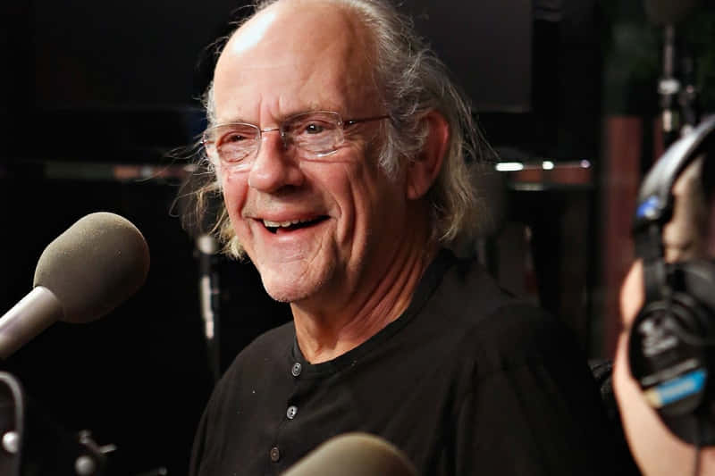 Christopher Lloyd Smiling During Interview Wallpaper