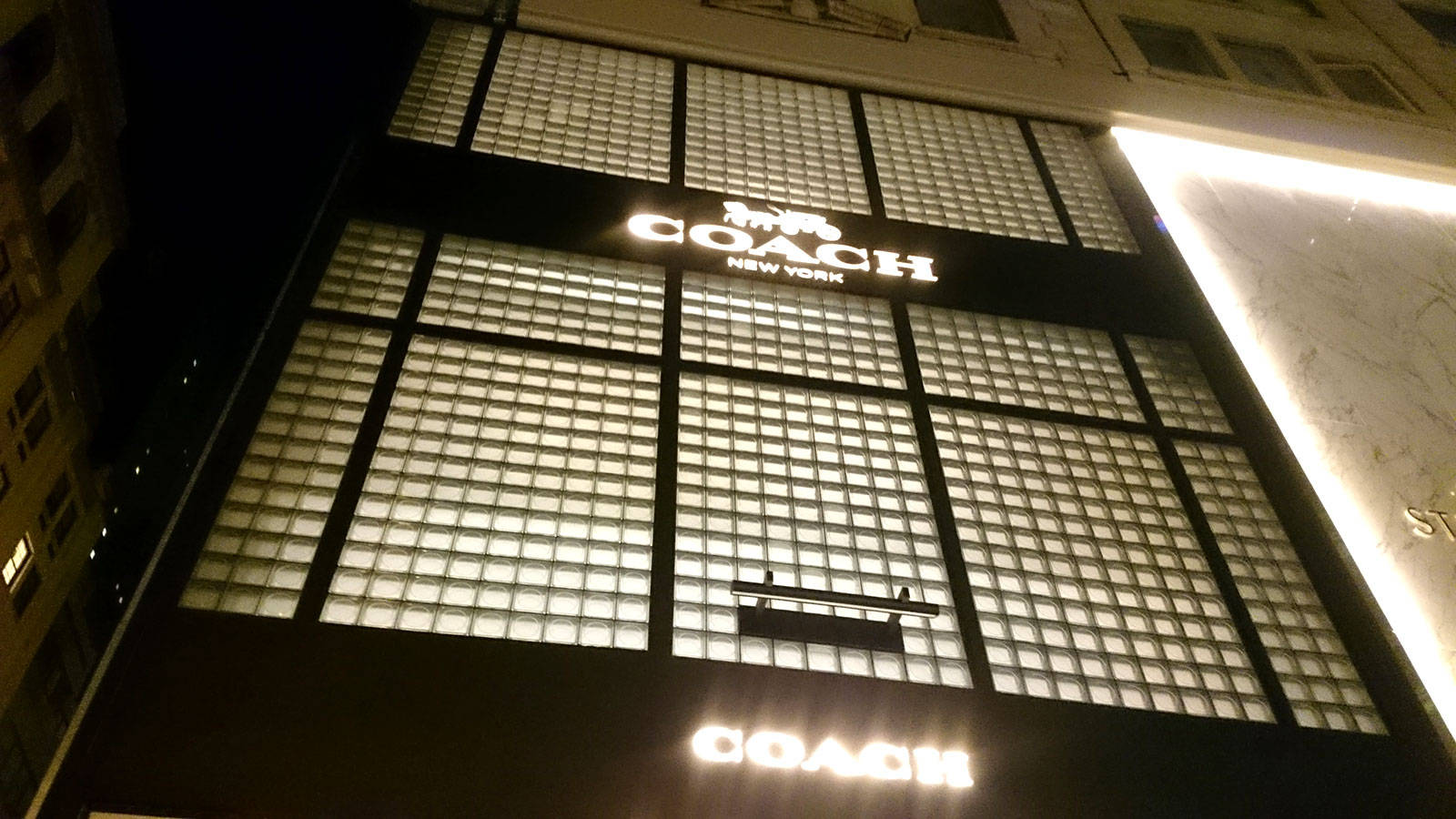 Coach Led Signage On Building Wallpaper