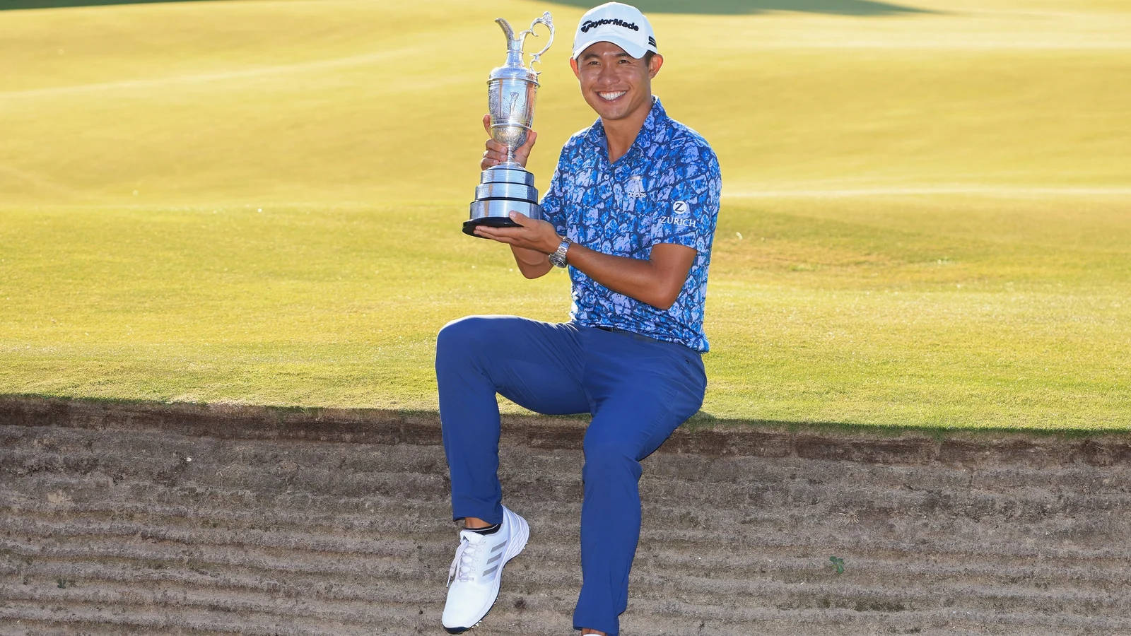 Collin Morikawa Holding A Silver Trophy Wallpaper