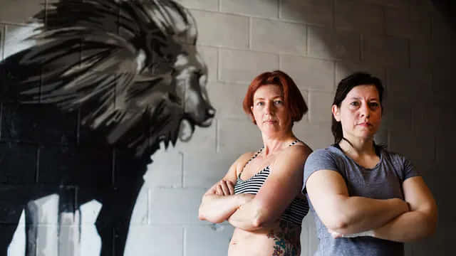 Confident Women Lion Mural Wallpaper