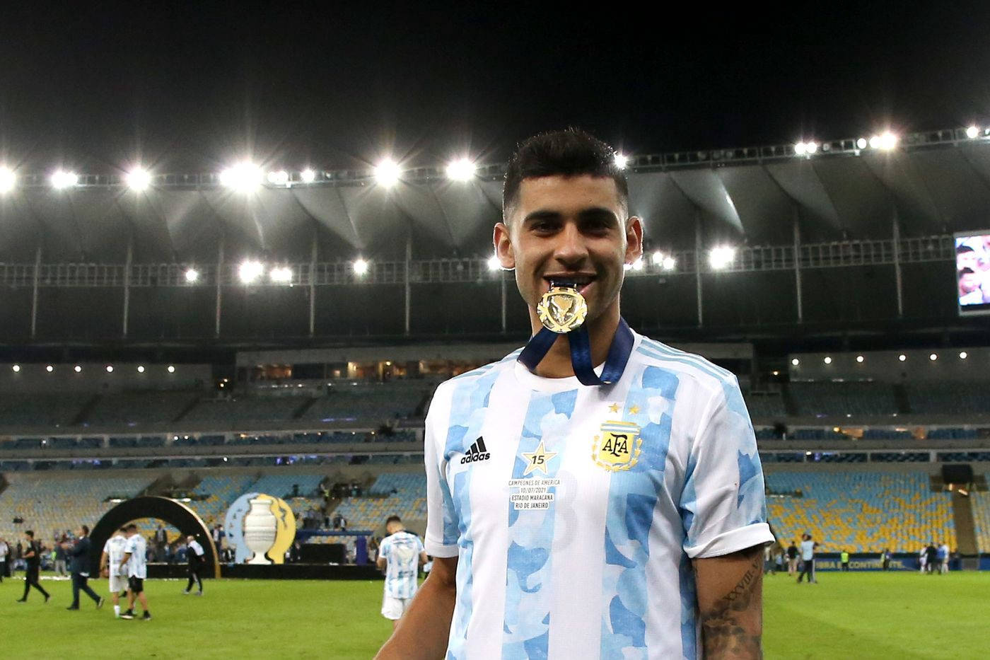 Cristian Romero Biting A Medal Wallpaper