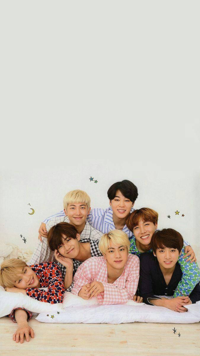 Cute Bts Group Lying Down To Sleep Wallpaper