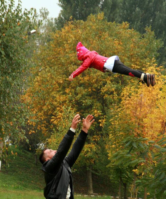 Dad Catching Child Midair Wallpaper