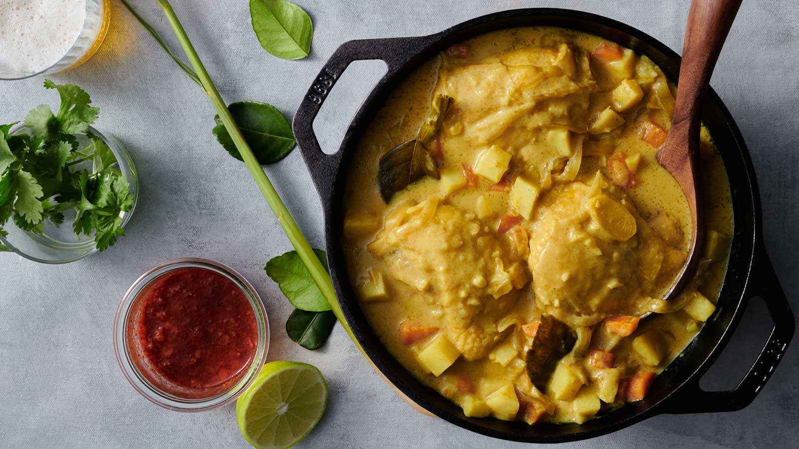 Delectable Yellow Curry In A Pot Garnished With Fresh Coriander Leaves Wallpaper