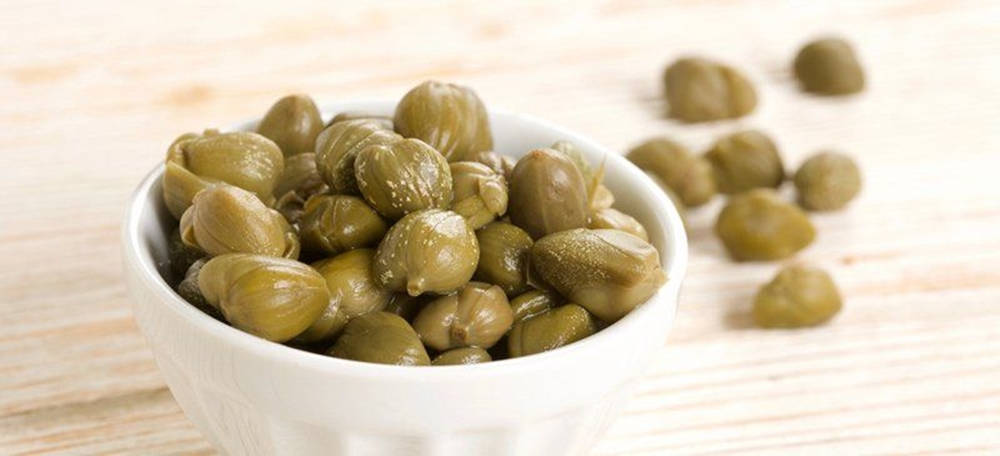 Delightful Capers In A Small Side Bowl Wallpaper