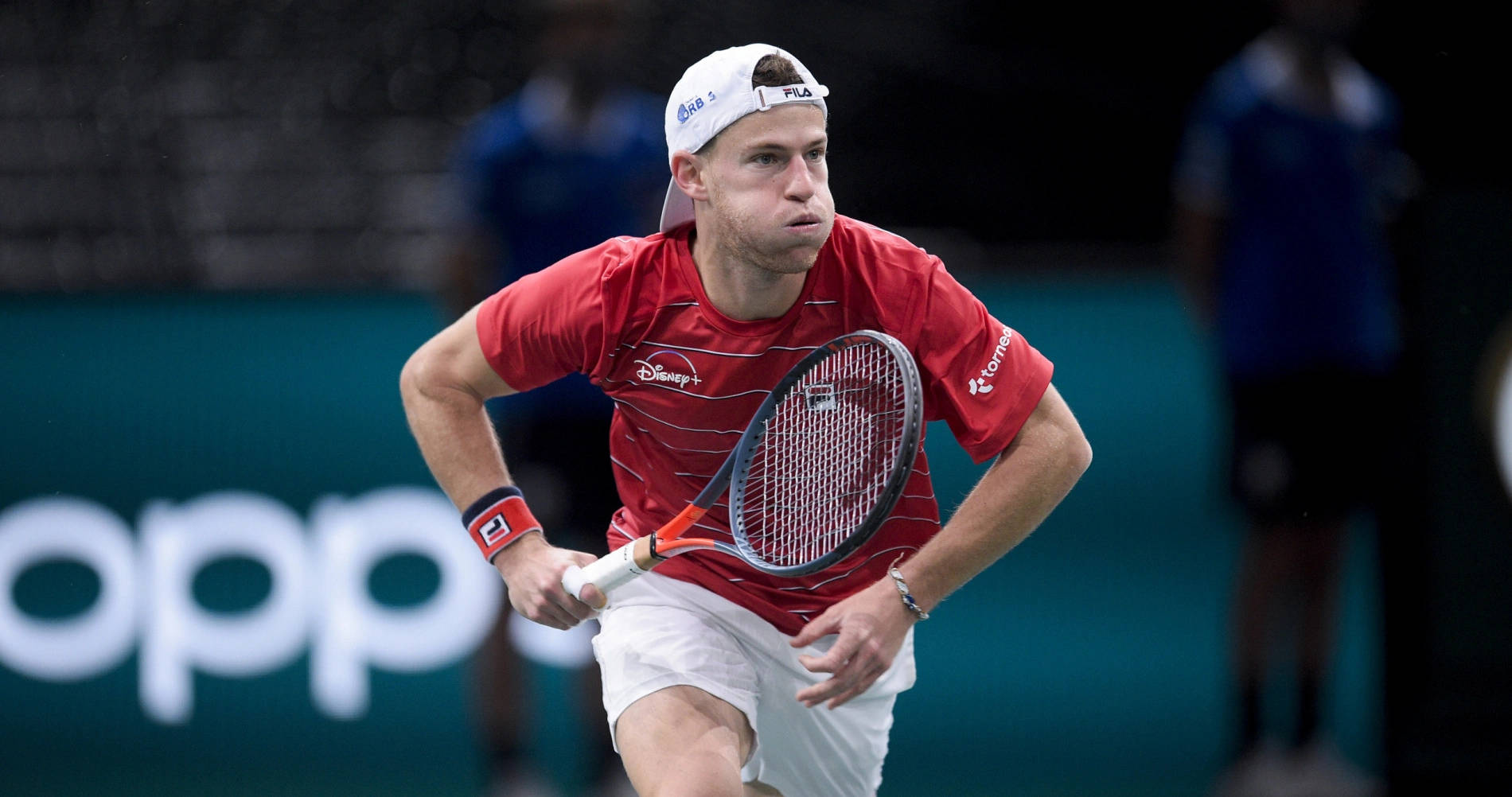 Diego Schwartzman Elegantly Charging For The Ball During A Tennis Match. Wallpaper