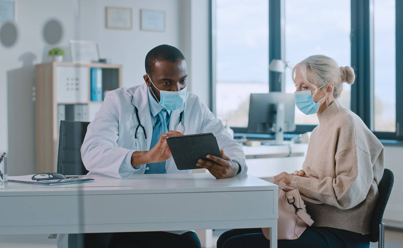 Doctor Consulting With Patient In Clinic Wallpaper