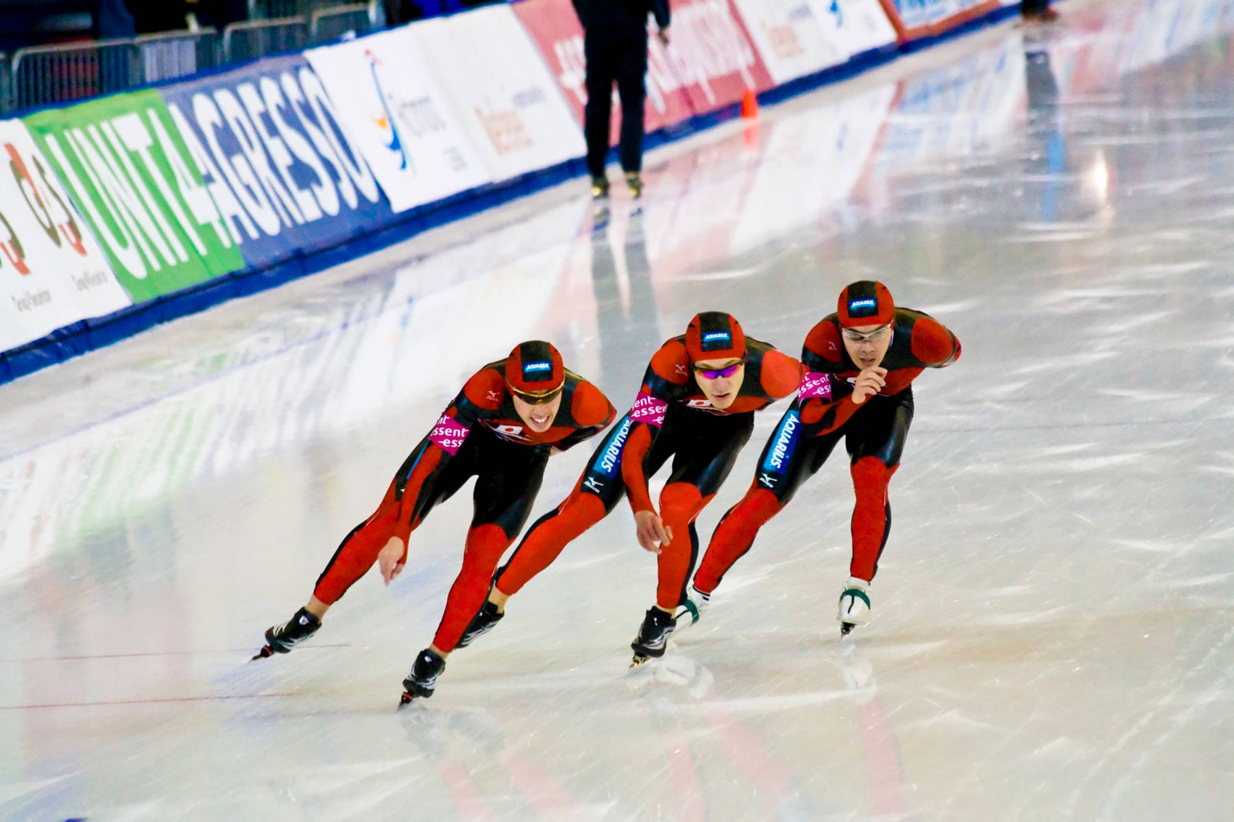 Dynamic Champion Speed Skaters In Action Wallpaper