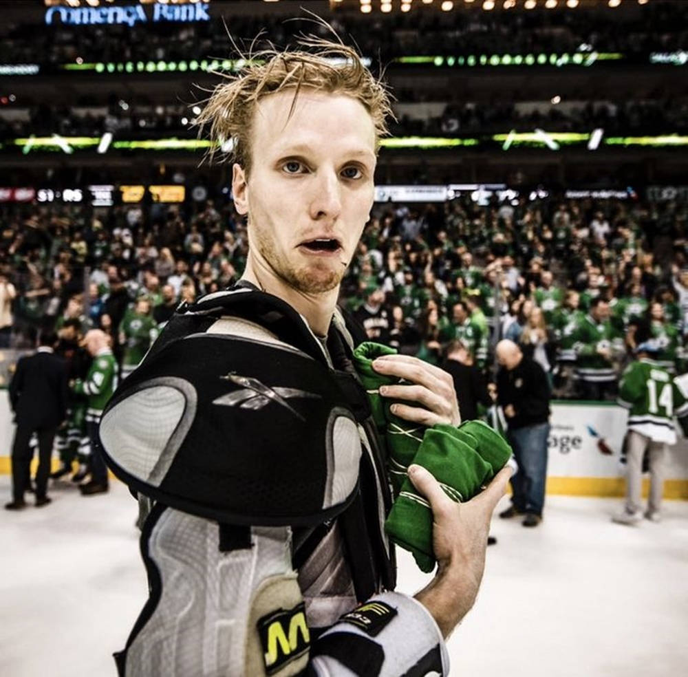 Dynamic Nhl Star - John Klingberg Removing His Jersey Wallpaper