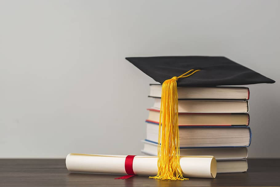 Education Stack Of Books With Graduation Cap Wallpaper