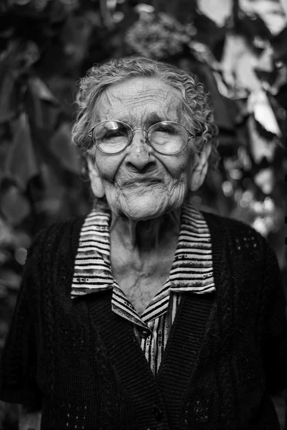 Elderly Woman Smiling Blackand White Portrait Wallpaper