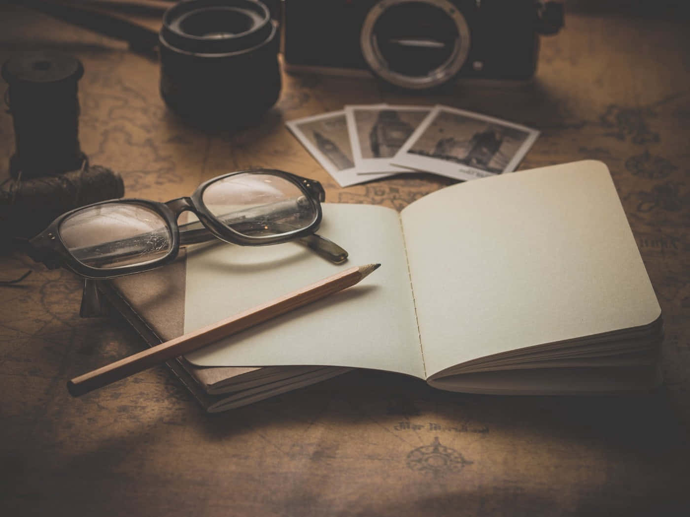 Engaged In Creativity - Writing Essentials Highlighting A Notebook And Eyeglasses Wallpaper