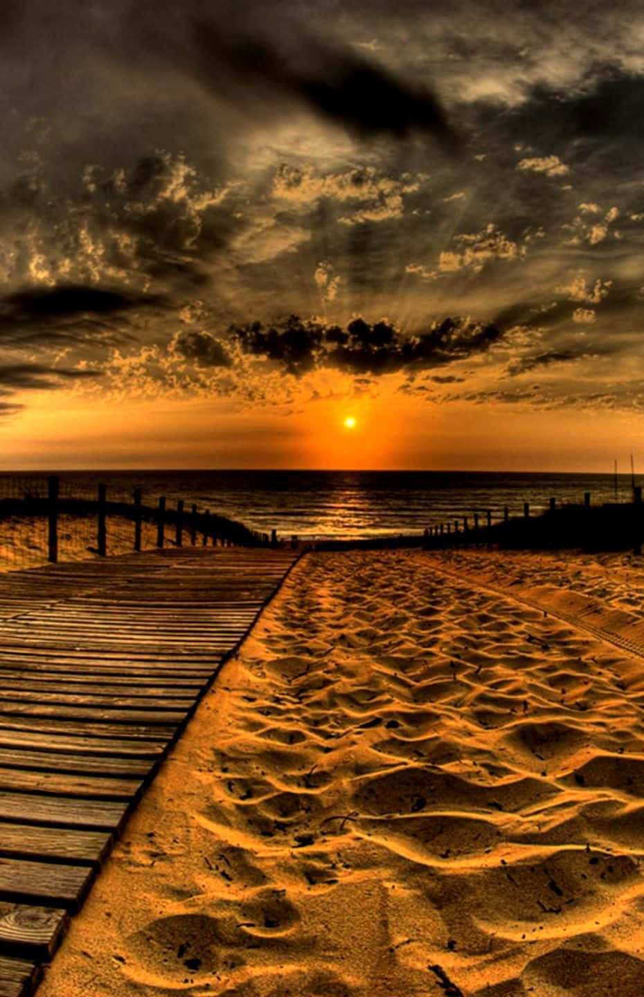 Enjoy The Beautiful View Of Sunset At The Beach With Your Brand New Iphone Wallpaper