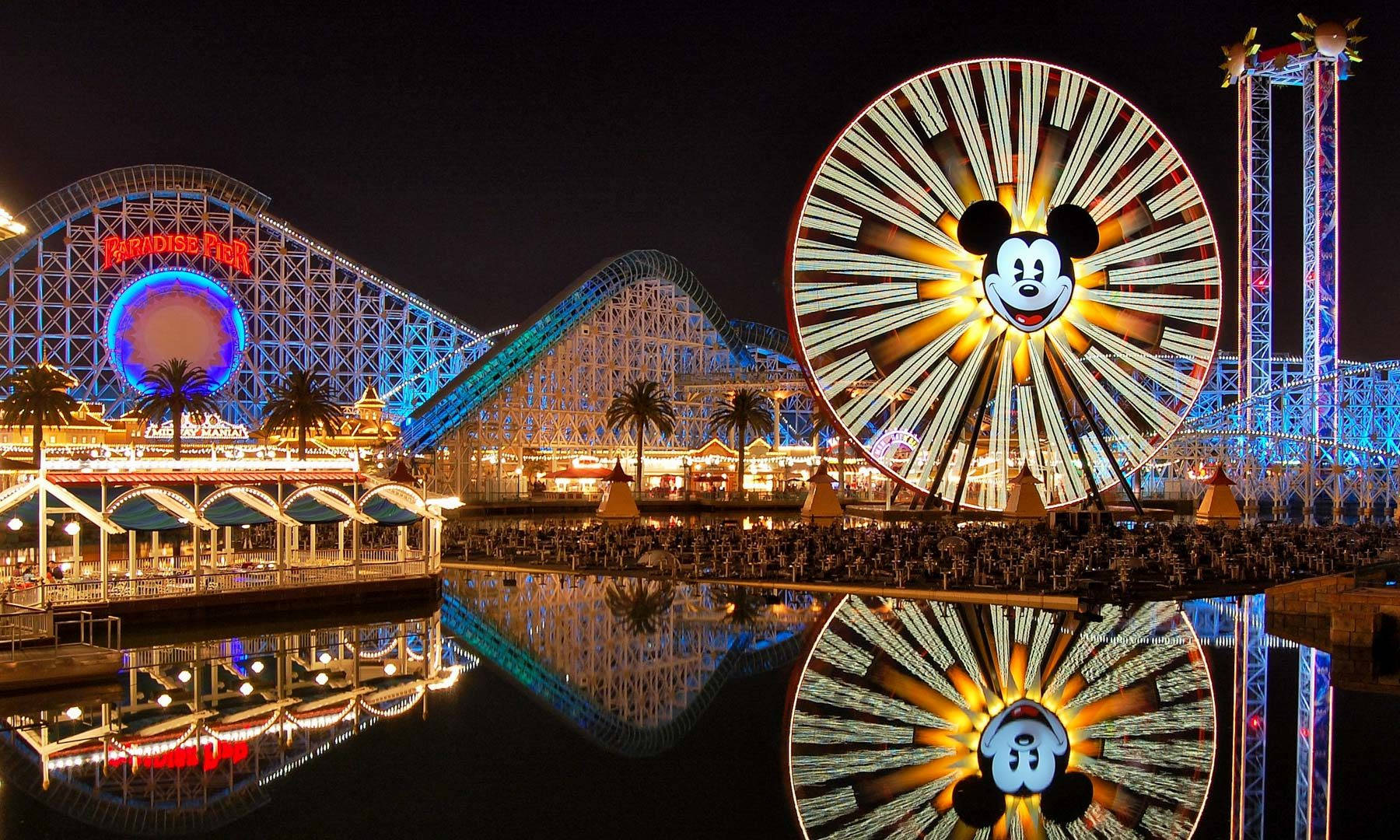 Enjoy The Magical View Of Pixar Pier At Night Wallpaper