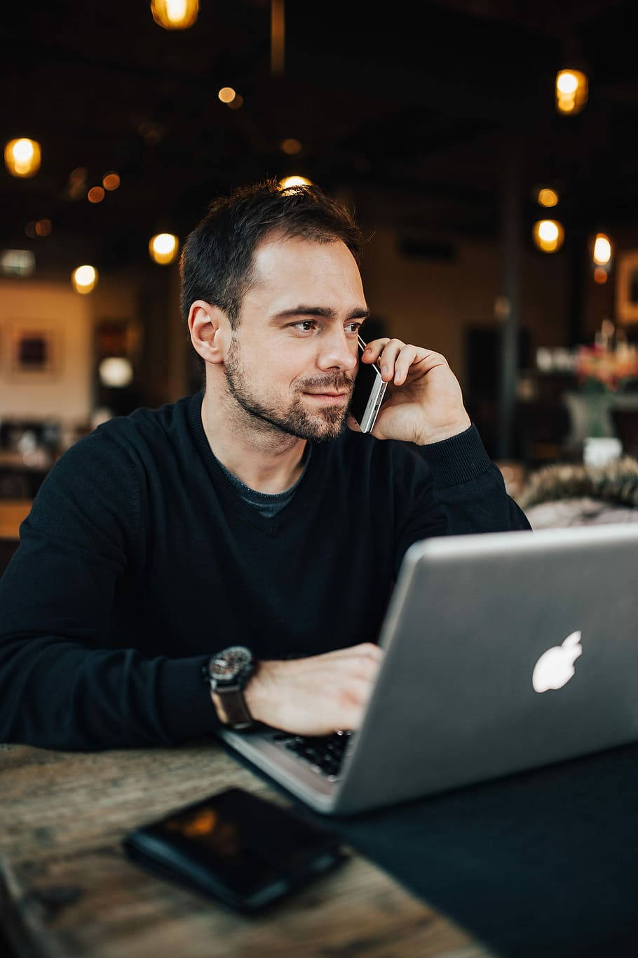 Entrepreneur Conducting Business Over The Phone Wallpaper