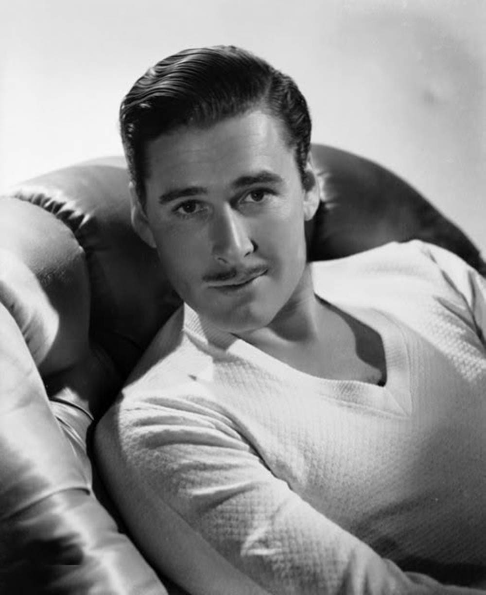 Errol Flynn Black And White Sitting Chair Wallpaper