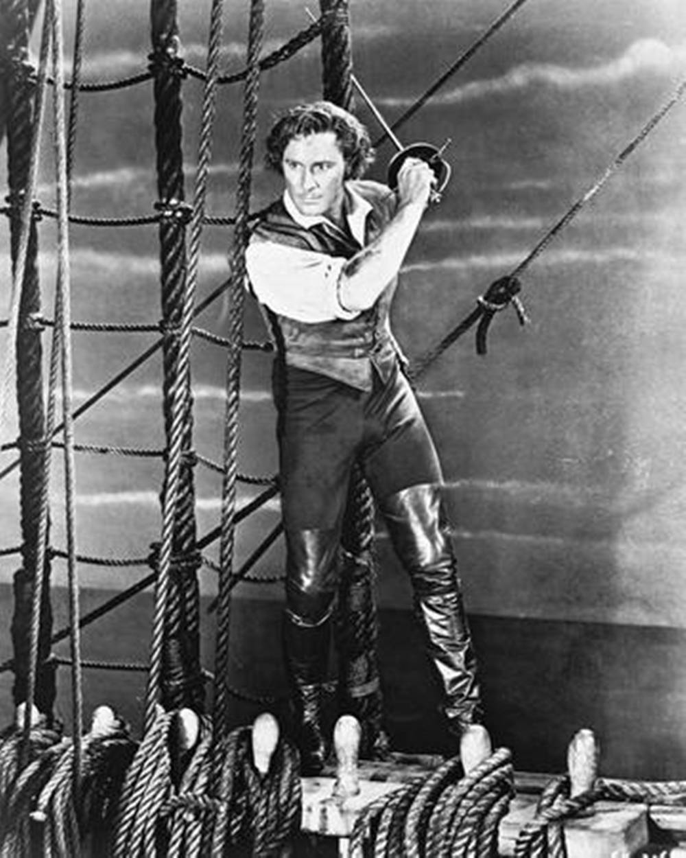 Errol Flynn Holding Sword On Ship Wallpaper