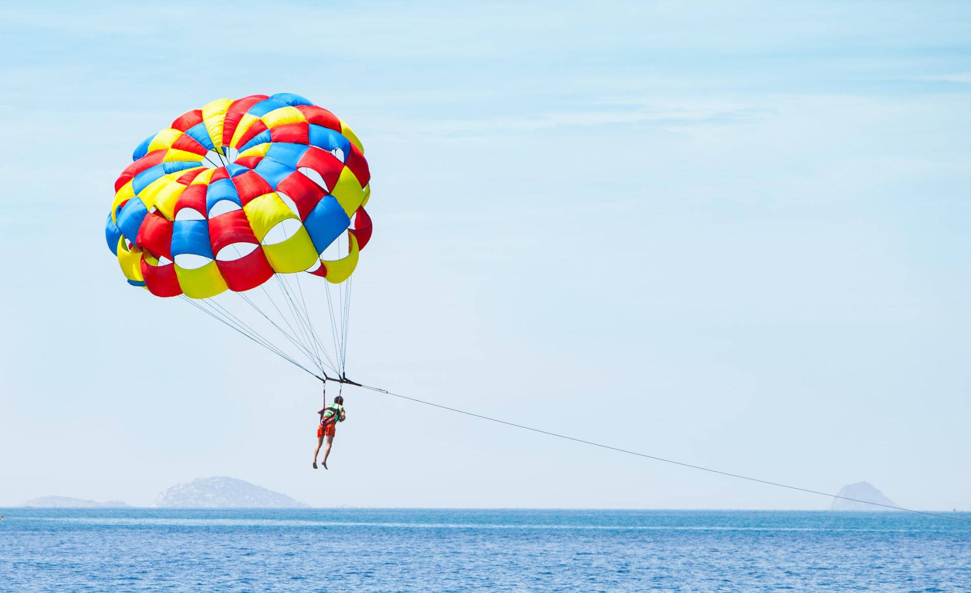 Exhilarating Parasailing Adventure In Snowy Mountains Wallpaper