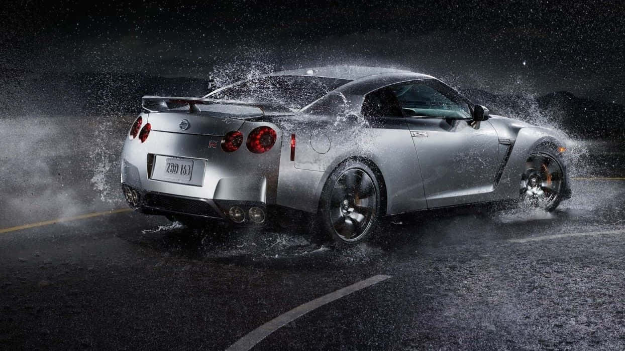 Eye Catching Nissan Gtr R35 Powers Through The Streets Wallpaper