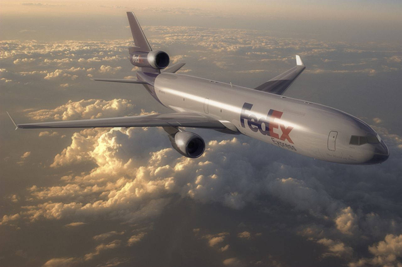 Fedex Passenger Plane Above Clouds Wallpaper