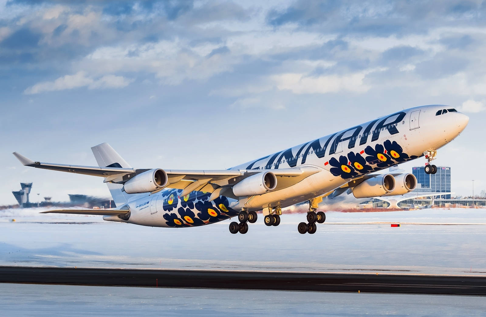 Finnair's Blue Floral Emblem - A Symbol Of Quality And Trust Wallpaper