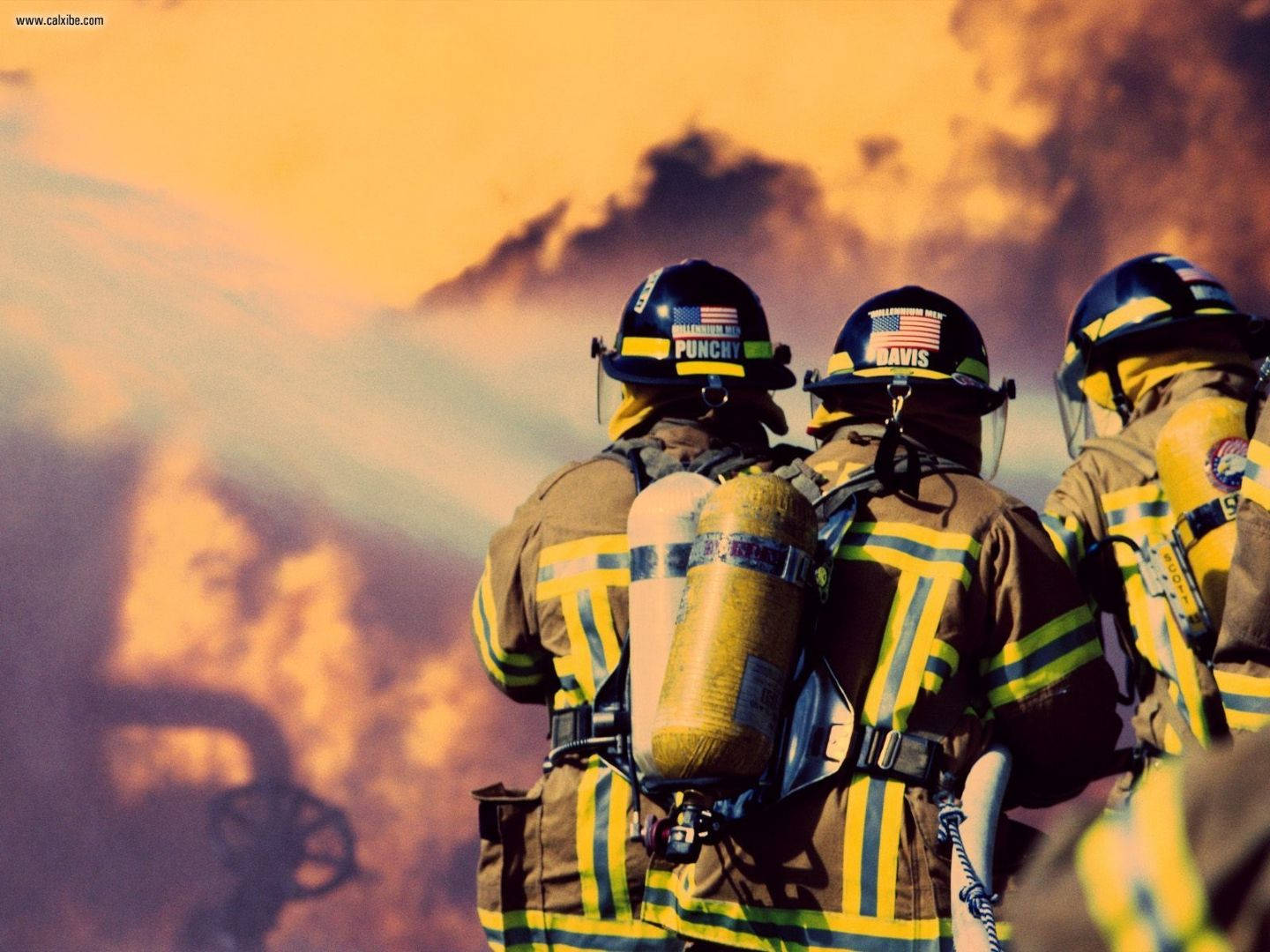 Fireman Pumping Water Into A Huge Fire Wallpaper