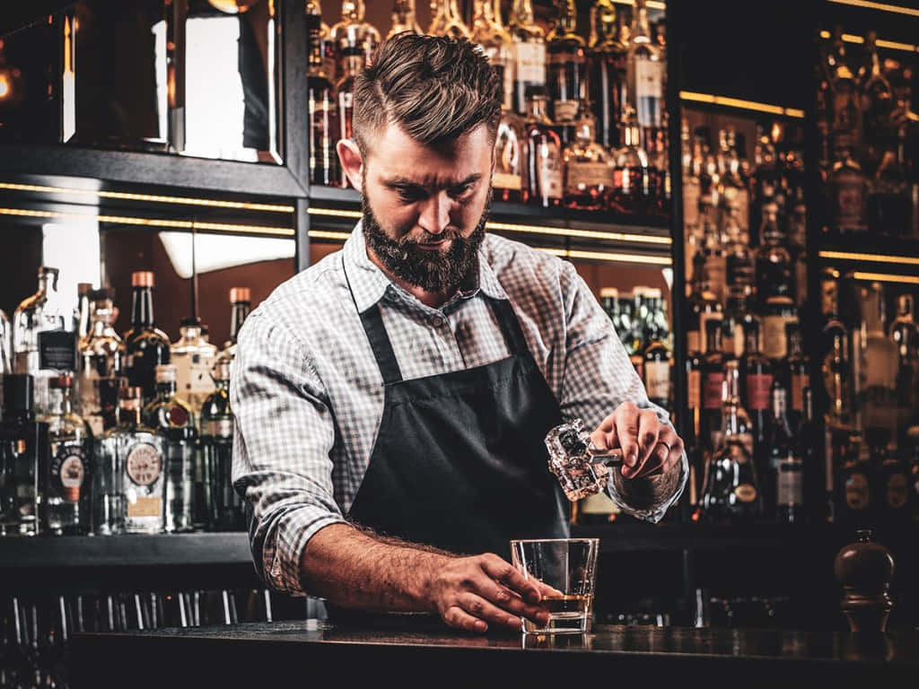 Focused Bartender Pouring Drink Wallpaper