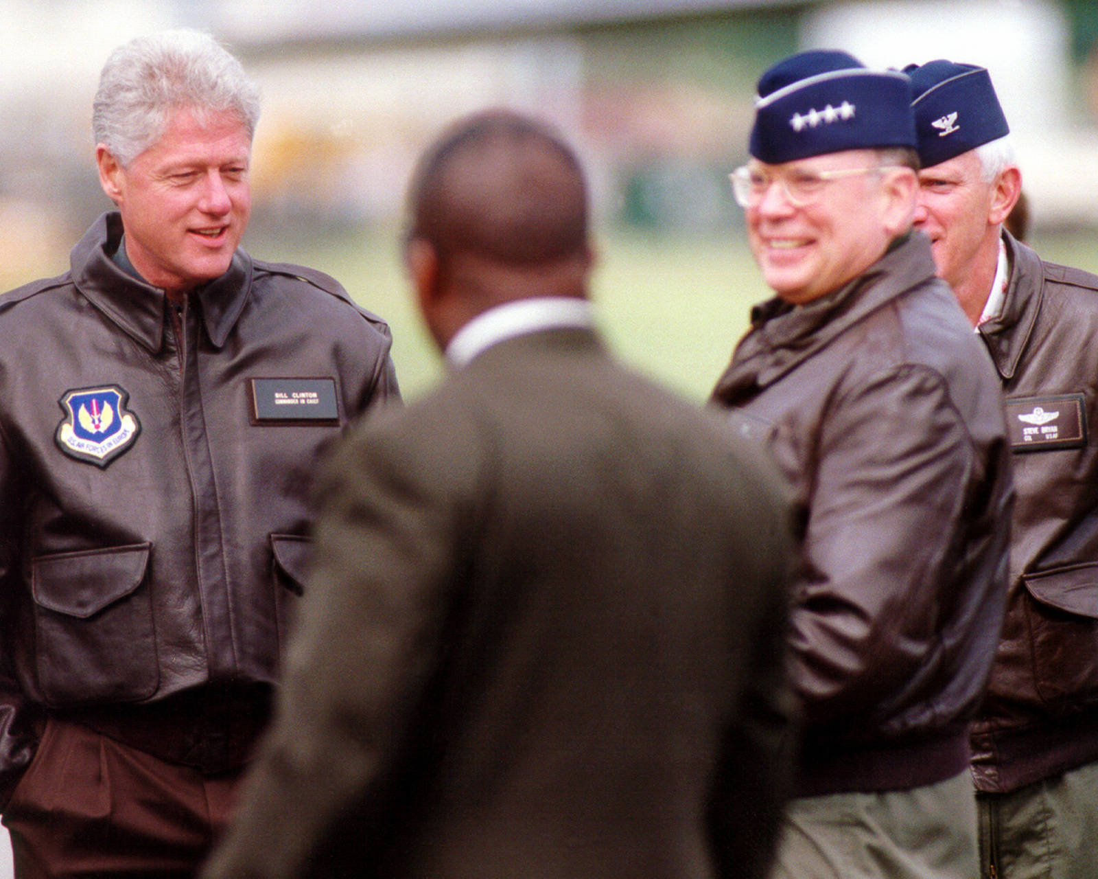 Former U.s. President, Bill Clinton, Stylishly Dressed In A Flight Jacket Wallpaper