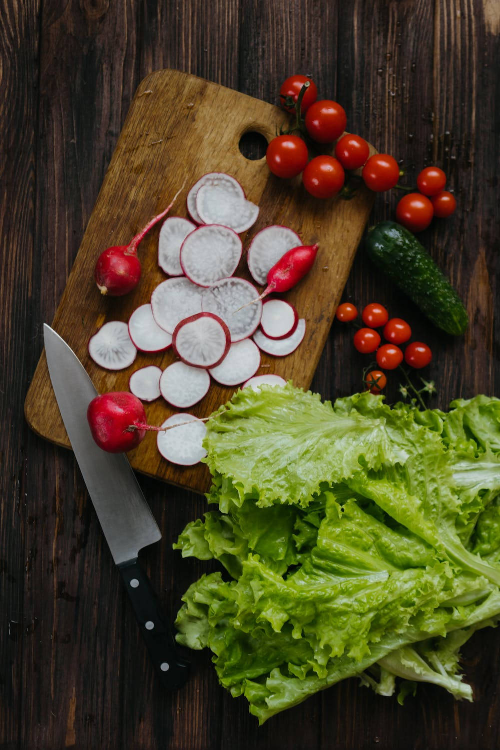 Fresh Red Radish Nestled Among Crisp Lettuce Leaves Wallpaper